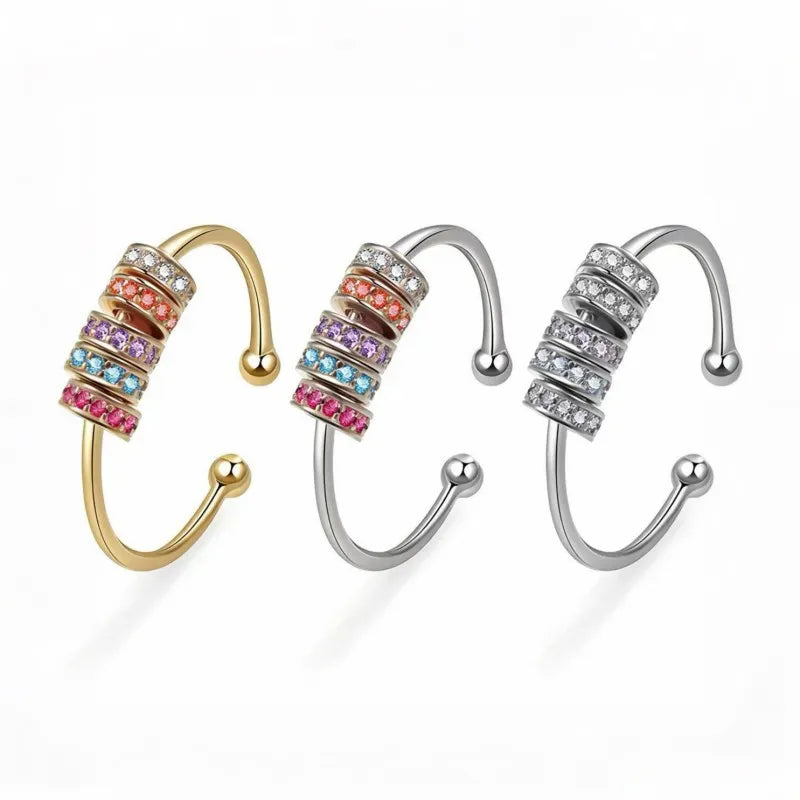 Mercury™ kinetic fidget rings: a 24k gold-plated style with multicolor AAA Zirconia, a silver stainless steel style with multicolor beads, and a silver style with clear crystal beads, all designed for smooth rotation and anxiety relief.