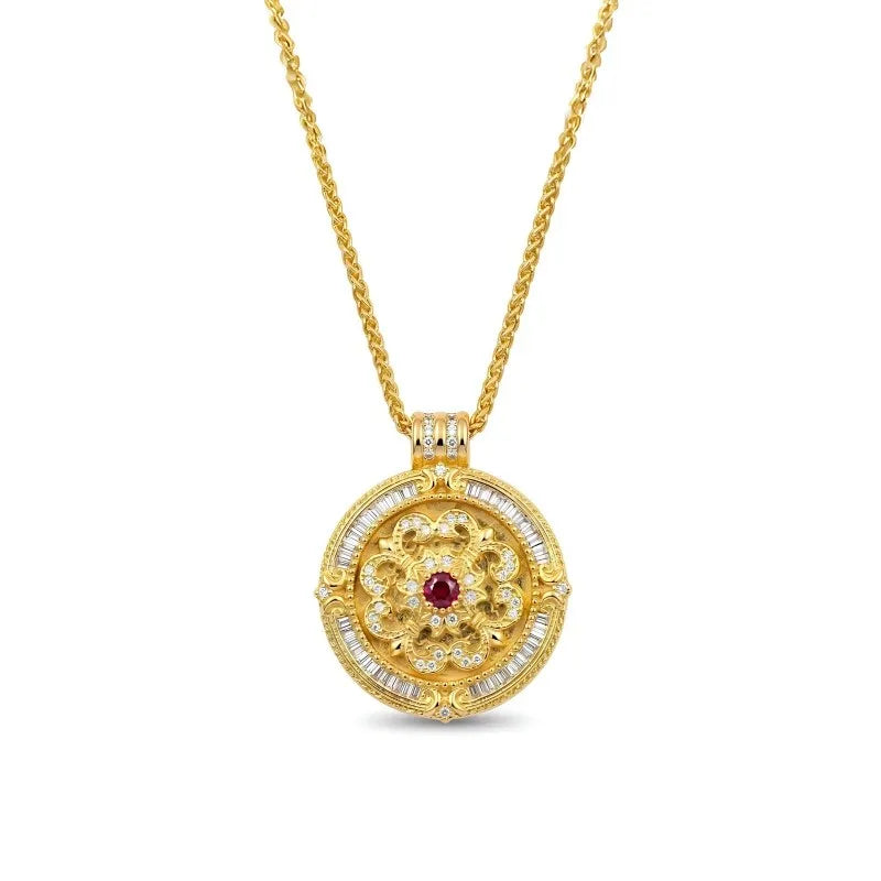 Rotating gold medallion necklace with a ruby center and diamond halo, featuring a fleur-de-lis motif on a chopin chain.