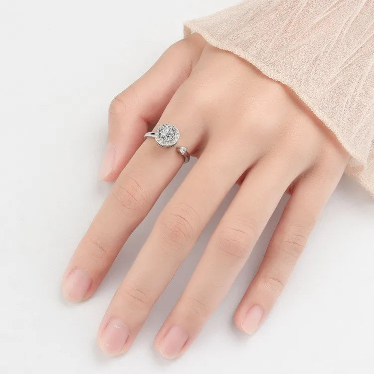 Lifestyle shot of the Mercury silver Interstellar Orbit spinning ring, featuring a rotatable CZ halo and celestial accents.