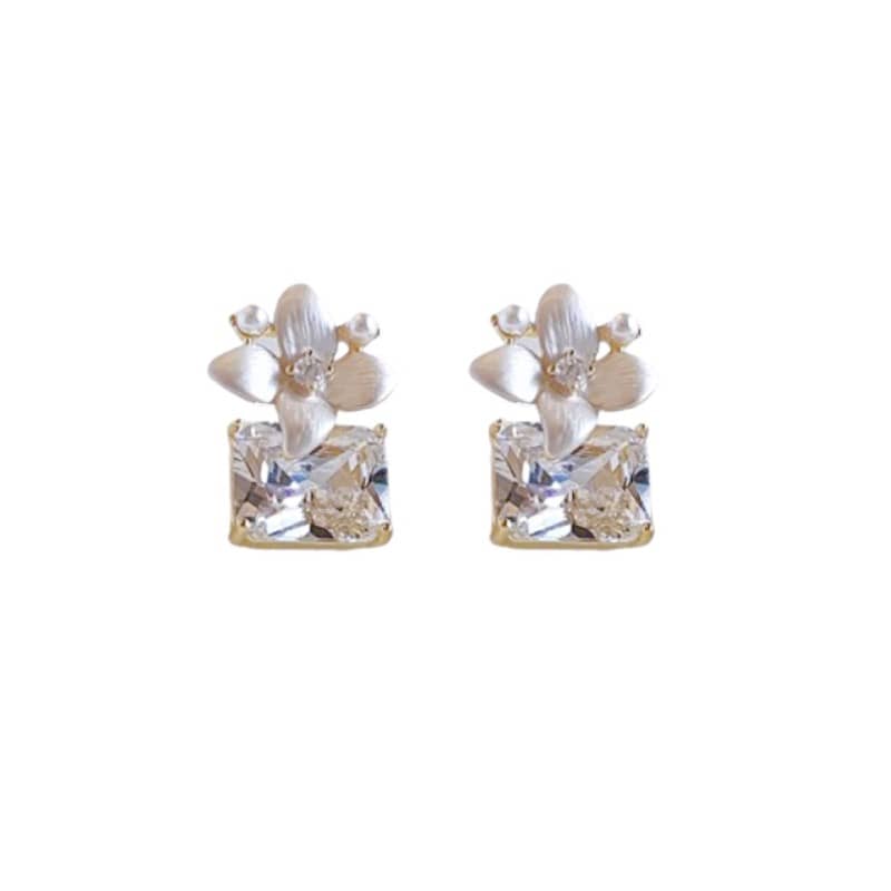 Mercury jewelry: Elegant matte gold-tone flower stud earrings featuring a large square crystal dangle and a delicate pearl accent, minimalist luxury style.