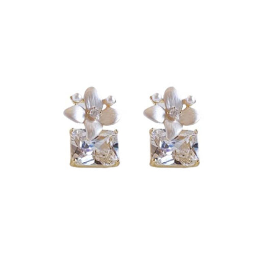 Mercury jewelry: Elegant matte gold-tone flower stud earrings featuring a large square crystal dangle and a delicate pearl accent, minimalist luxury style.