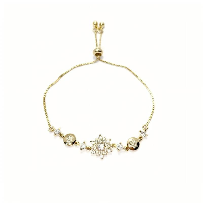Mercury brand 36cm adjustable gold bolo bracelet with central cubic zirconia starburst motif, laid flat on white background.